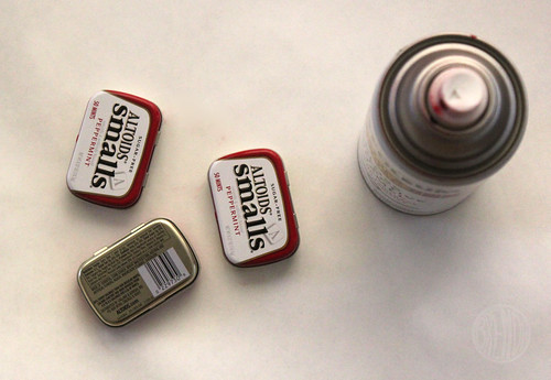small altoid tins on a table with a can of red spray paint 