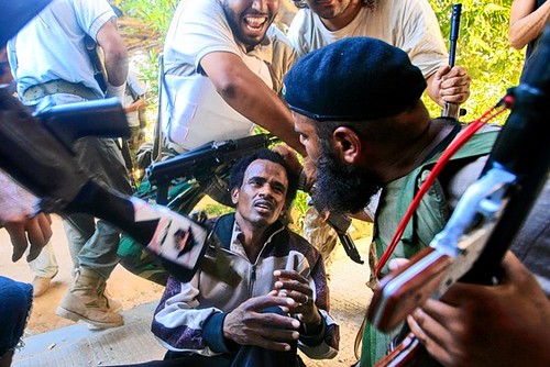 US-NATO supported counter-revolutionary rebels hold Libyan patriot at gunpoint during their imperialist-backed siege of the country during late August 2011. The Pentagon and NATO have terrorized the North African state since February.  by Pan-African News Wire File Photos