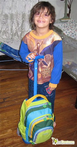a kid holding a jworld kid rolling backpack