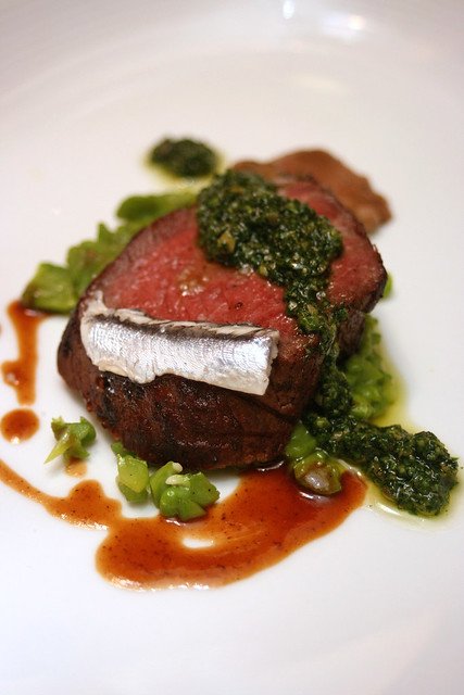Tuscan Style Dry-Aged Ribeye, with Wild Mushrooms, Taggliasca Olives, Fava Beans and Sauce Salsa Verde