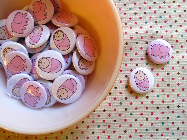 Baby girl buttons and baby elephant buttons.
