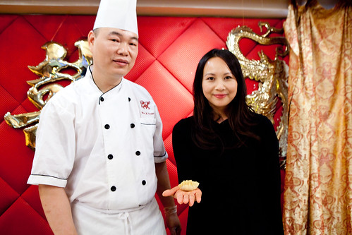 Ching-He Huang holding her dumpling and the dim sum chef of Golden Unicorn