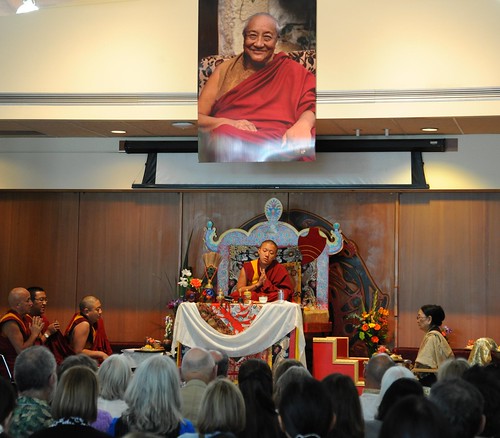 Dilgo Khyentse Yangsi Rinpoche saying prayers, throne, a photograph of his prior incarnation above, Dagmo Kushog Sakya (on the right), (monks on left) Rabjam Rinpoche, Changling Rinpoche, Mathieu Ricard, Vancouver BC, on stage, Lotus Speech Canada by Wonderlane