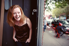 Colleen Raney, a white woman with reddish hair, laughs and looks away from the camera