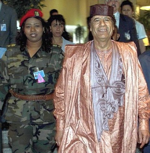 Libyan leader Col. Muammar Gaddafi with a woman bodyguard. A new radio station has been launched to encourage the resistance to the US-NATO puppet regime now occupying the North African state. by Pan-African News Wire File Photos
