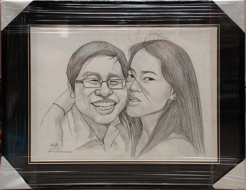 couple portraits in pencil with black borders and frame