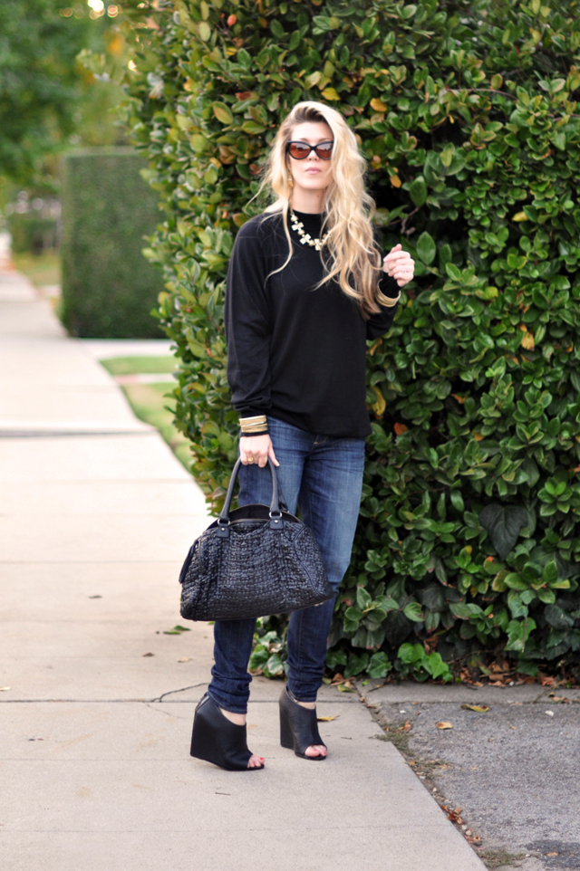 black sweater + brass jewelry+jeans+black wedges+black woven leather bag+cat eye sunglasses+long messy hair