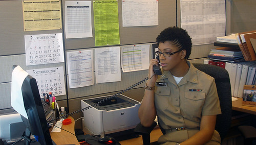 Lt. Nisha Antoine, in her U.S. Public Health Service Commissioned Corps uniform, works at her desk in one of the Food Safety and Inspection Service’s headquarters offices. 