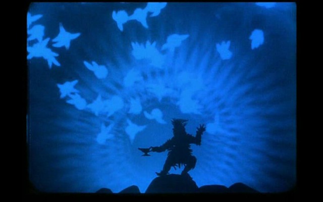 A black silhouette of Witch releasing good spirits, visualized with lighter shadows from the lamp against a blue background.