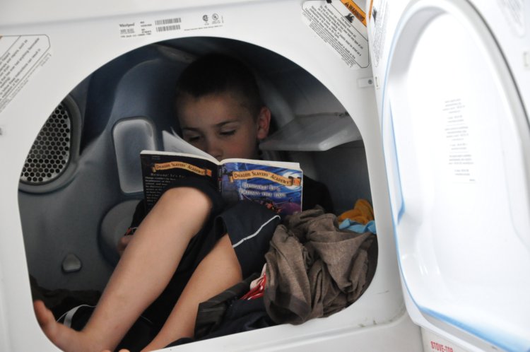 Luke reading in dryer