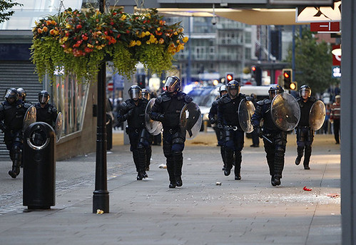 Manchester cops in formation patrol the streets in attempts to smash the youth rebellion that has spread throughout various regions of England. The outbreak was sparked by police brutality and the economic crisis. by Pan-African News Wire File Photos