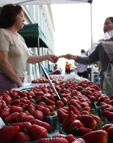 A woman makes a purchase at her local farmers market. A single farmers market purchase can have a big impact on the local economy.  (Photo courtesy of Real Time Farms)A woman makes a purchase at her local farmers market. A single farmers market purchase can have a big impact on the local economy.  (Photo courtesy of Real Time Farms)
