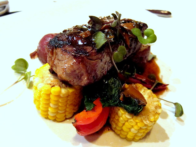 Grilled 10 oz Beef Striploin, Mushroom Veal Jus, served with Roasted Herbed Polenta and Peppers