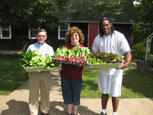 Chaplin Wally Merner, manager of LICC Emergency Food Center, Ann McPartlin from The Garden at St. Mark's, Gregory Lucas, food pantry worker, showcase freshly harvested produce. 