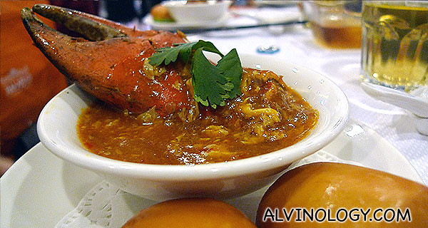 Serving portion of Chili Crab with delectable fried Mantous