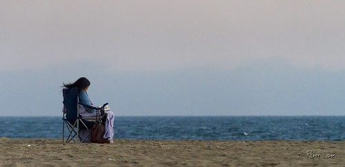 Woman sitting on Seal Beach