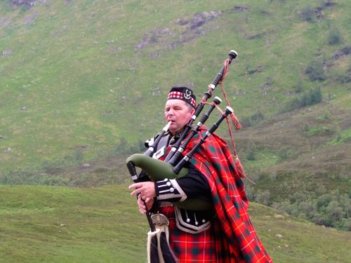 Bagpiper in the  Scottish Highlands by Ginas Pics