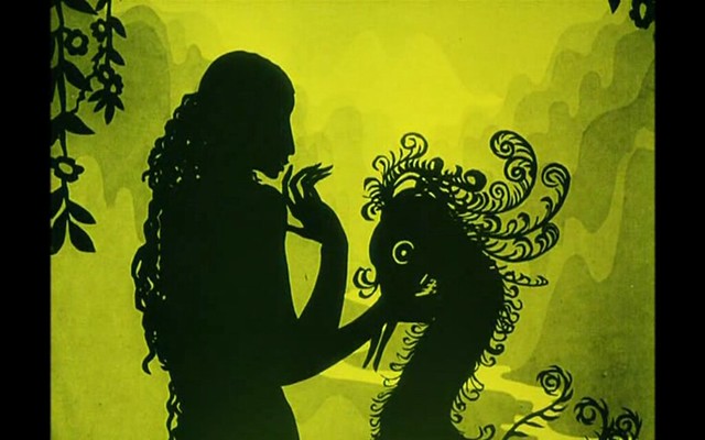 a black shadow puppet of a woman holding a  bird against a yellow background
