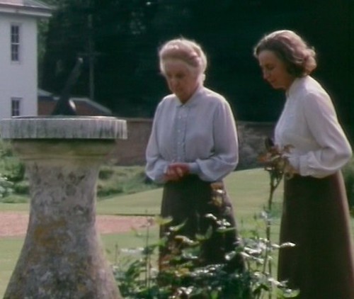 Miss Marple and Mrs Bantry in the garden, wearing very similar long skirt and white shirt