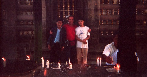 Steve D. near the Vajrayana Seat of Lord Buddha, with two local friends, one holding a mala, making candle offerings, for the benefit of all sentient beings, Pilgrimage 1993, Bodhgaya, HP, India by Wonderlane