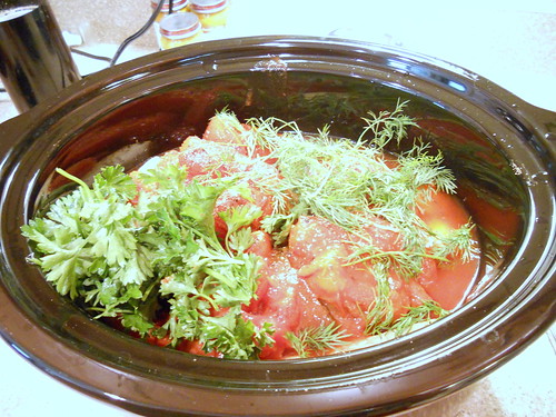 Layered ingredients in slow cooker topped with fresh parsley and fresh dill.