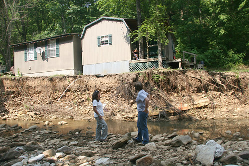 Margaret Lonadier (left), NRCS district conservationist for Boone and Newton counties, and Deanna Young discuss the work that will done to stabilize the stream bank beside Young’s house. 