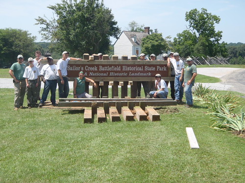 YCC supervisors and crew with new park sign. The Overton-Hillsman House is in the background.