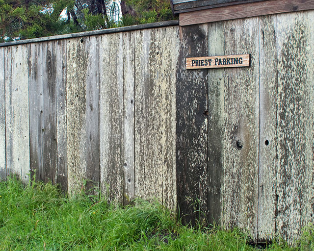 A rustic gray weathered wooden fence with a 