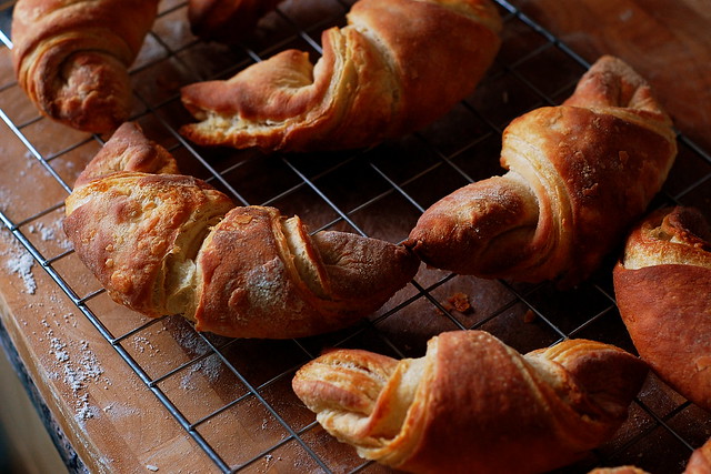 Home-made croissants cooling on a baking rack