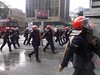 Police forces clearing the area, armed with rifles and batons by freemalaysiatoday