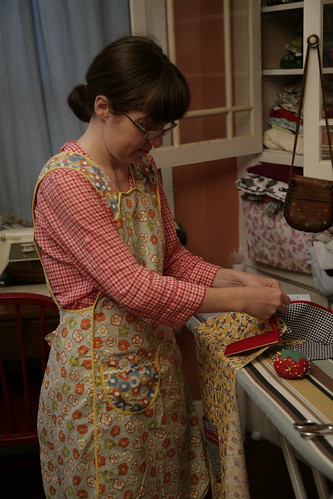 Sewing an apron, in an apron.