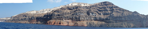 Cliffs on the southern side of Therasia, Santorini, showing several lava flows from the Therasia Shield phase of the volcano (55,000-22,000 years ago). Also note the white Minoan deposits on top, from the eruption 3,600 years ago.