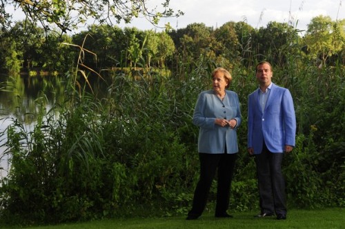 German Chancellor Angela Merkel and Russian President Dmitry Medvedev pose at the border of the Berenbosteler See lake ahead of a dinner at the "Landhaus am See" restaurant in Garbsen near Hanover, central Germany, on July 18, 2011. The leaders of Russia 