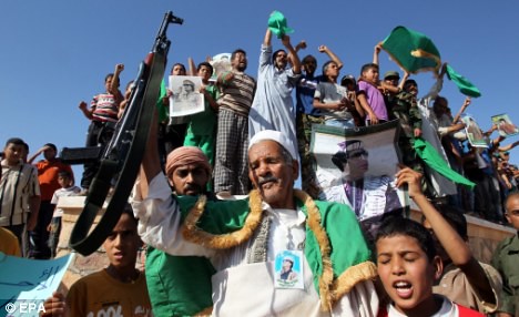 Libyans rally in defense of their revolution led by Muammar Gaddafi. The US/NATO forces have been bombing the North African state for nearly four months. by Pan-African News Wire File Photos