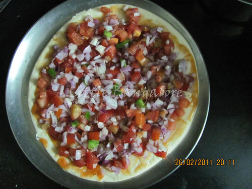 Pizza base with chopped vegetables