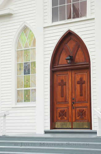 An architectural photo of a beautiful wooden Christian church door.