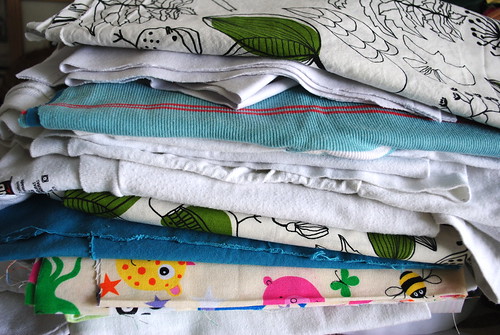 A stack of fabric and tee shirts to be upcycled into burp cloths