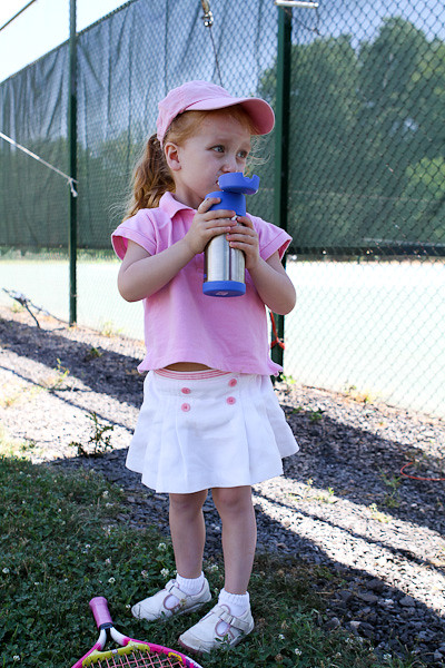 Abigail taking a sip looking on court.jpg