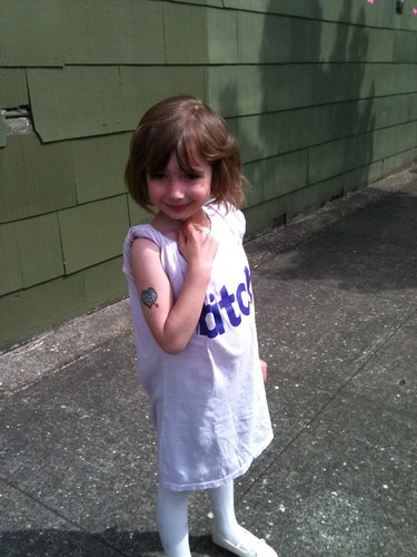 young girl wearing a bitch t-shirt and tattoo