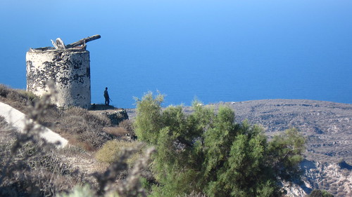 A hunter looks out over the Greek island of Therasia, Santorini.