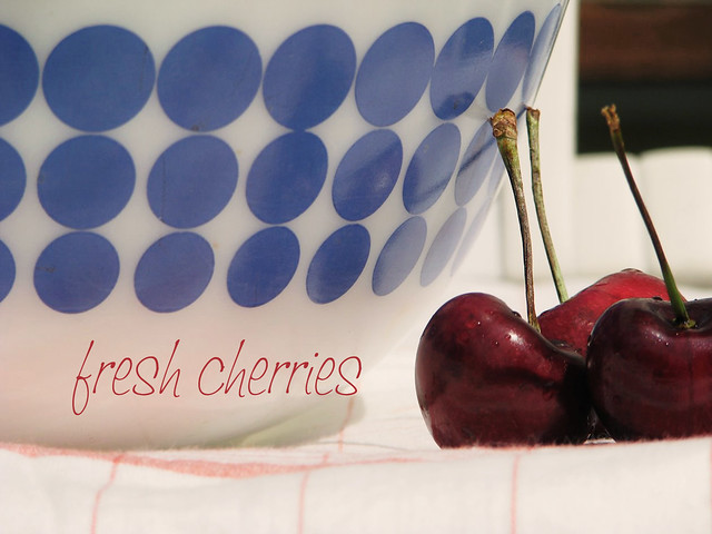 cherries next to a bowl