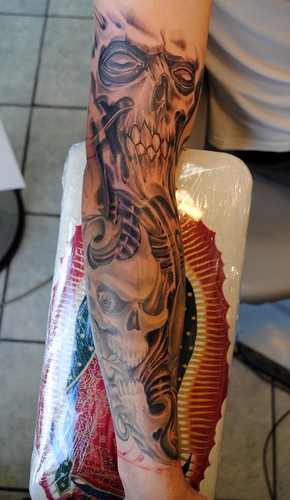 Full sleeve tattoo with skulls