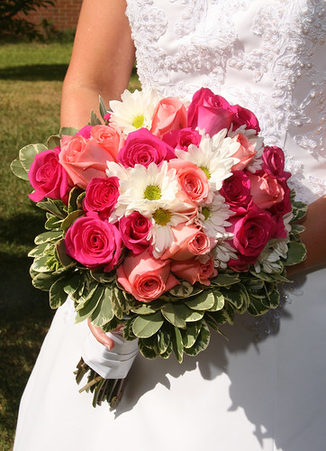 This bouquet features dark and light pink Roses and white accenting Daisies