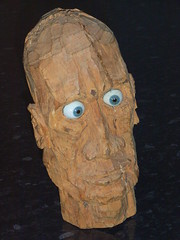 Carved wooden head with glass eyes
