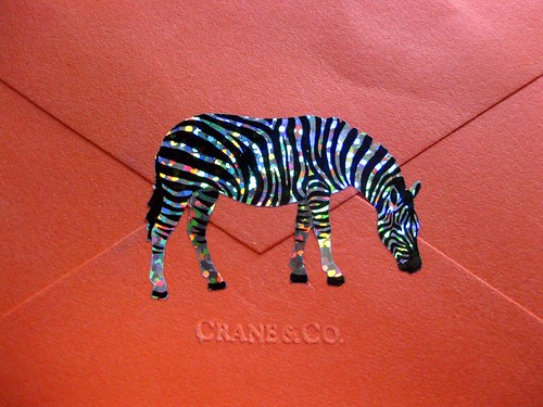 Sparkle zebra sticker on orange Crane envelope, close-up
