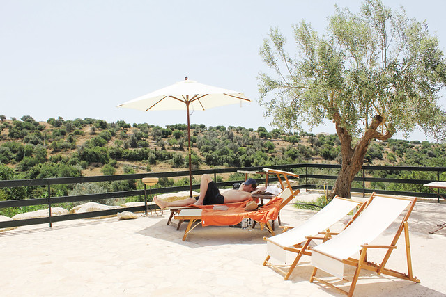 lounging poolside at relais parco cavalonga in ragusa, sicily