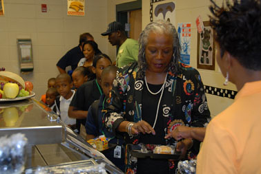 Food and Nutrition Service Administrator Audrey Rowe leads Sherwood Acres Elementary Magnet School students through the breakfast line at their Back to School Breakfast with SWAG (Students With Academic Greatness) Event on August 16, 2011, in Albany, Ga. 