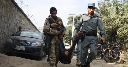 US-NATO puppet Afghan forces carry away body in the aftermath of the resistance attack on the American embassy in Kabul. The Taliban has escalated the resistance with coordinated attacks during the second week in September 2011. by Pan-African News Wire File Photos