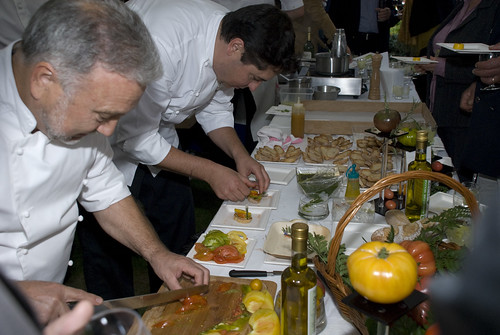 Chef Yves Roquel and his assistant preparing a tomato mix (from the garden) on bruschetta bread with basil (from the garden)
