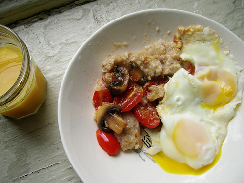 fried eggs and oatmeal with tomatoes and mushrooms